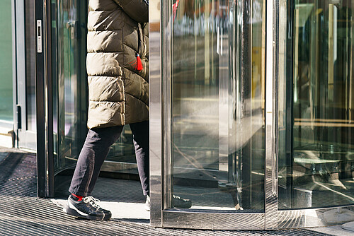 Photography of revolving office door entrance of modern business center. Manager coming. Business concepts and lifestyles.